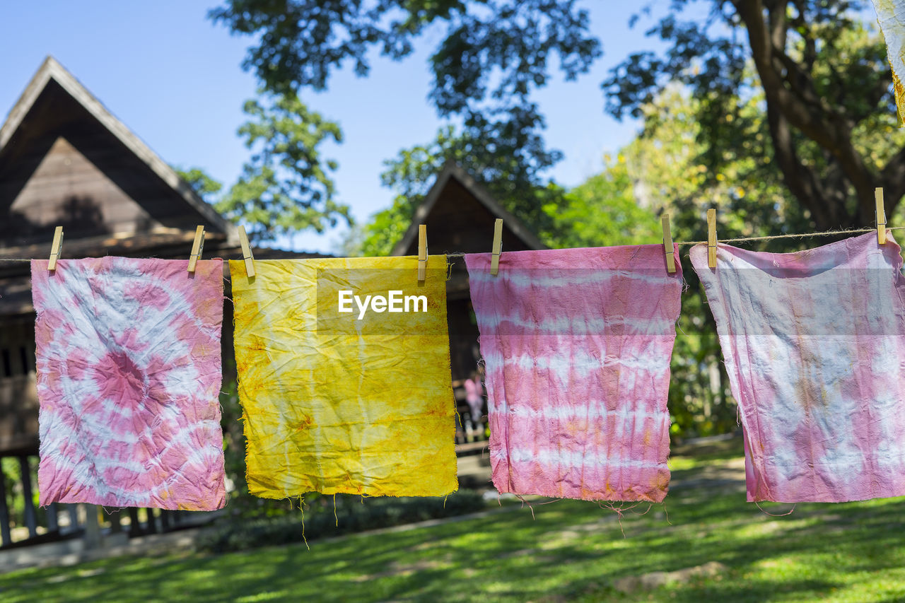 Colorful abstract tie dyed fabric hung up to dry.