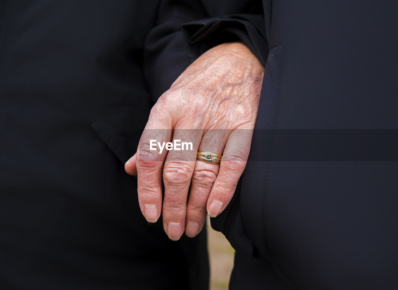 Midsection of woman wearing ring