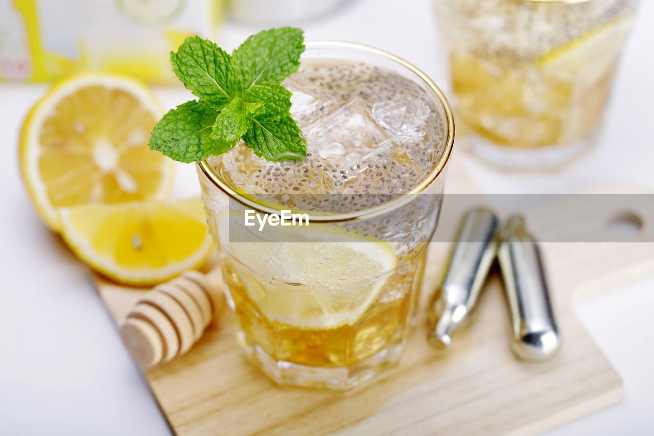 HIGH ANGLE VIEW OF COCKTAIL WITH GLASS OF JUICE