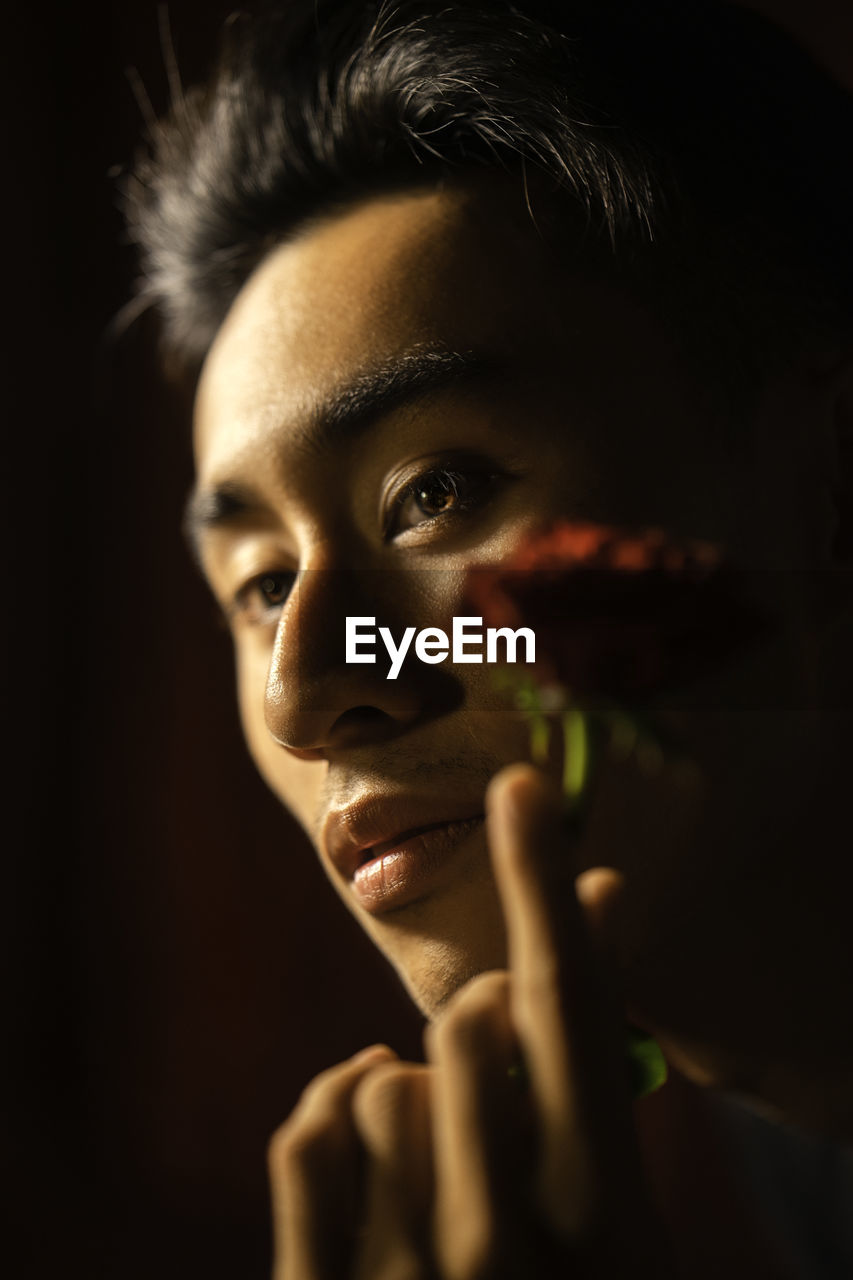 CLOSE-UP PORTRAIT OF TEENAGE BOY WITH EYES