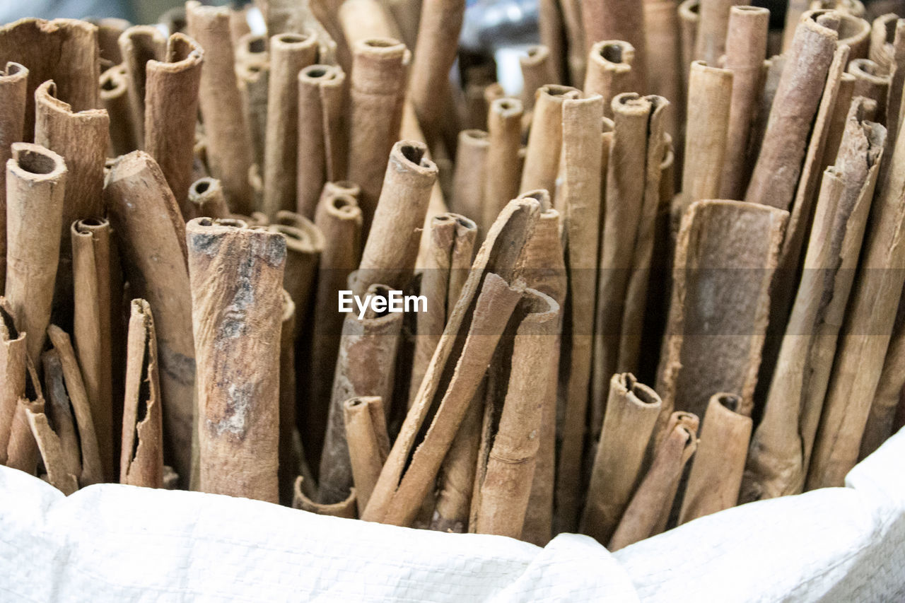 Close-up of cinnamon sticks in sack