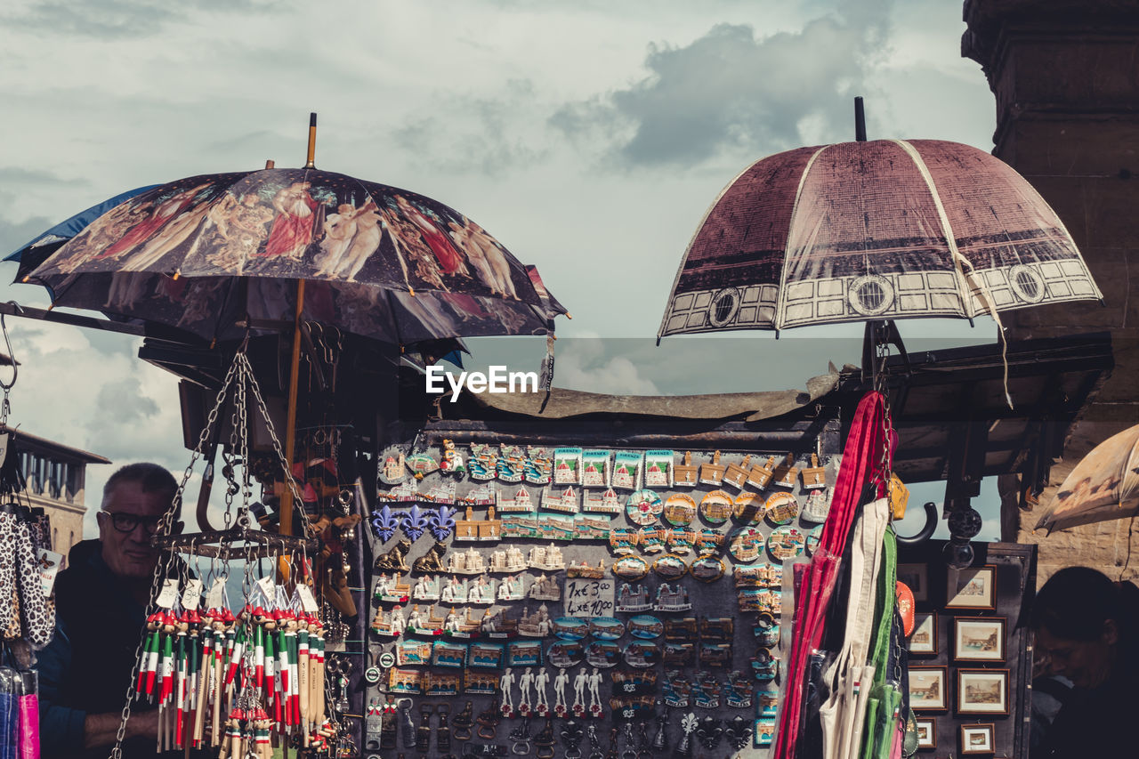 PEOPLE IN MARKET STALL AGAINST SKY