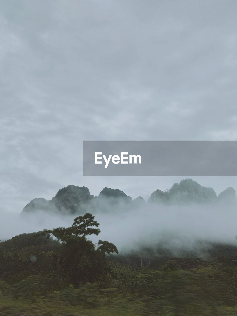 SCENIC VIEW OF LANDSCAPE AGAINST SKY DURING FOGGY WEATHER