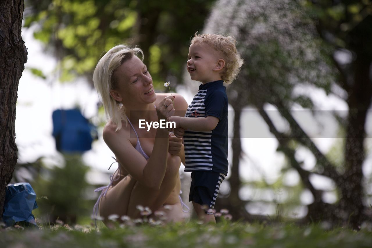 Side view of mother and daughter in park