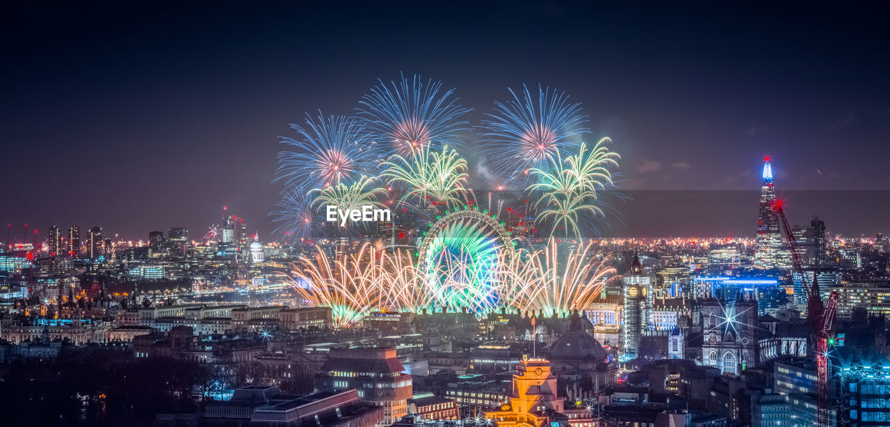 High angle view of firework display at night