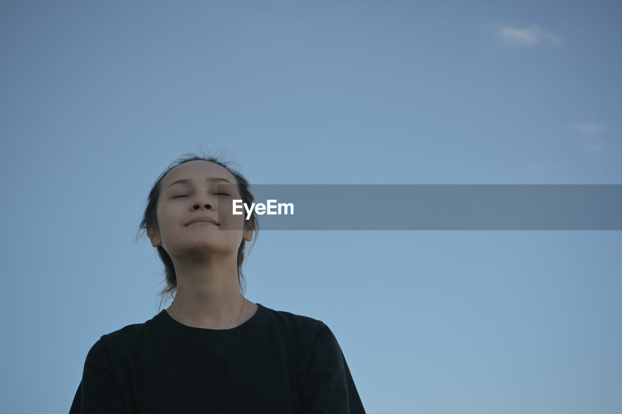 Series photo of young woman in positive emotion with blue sky