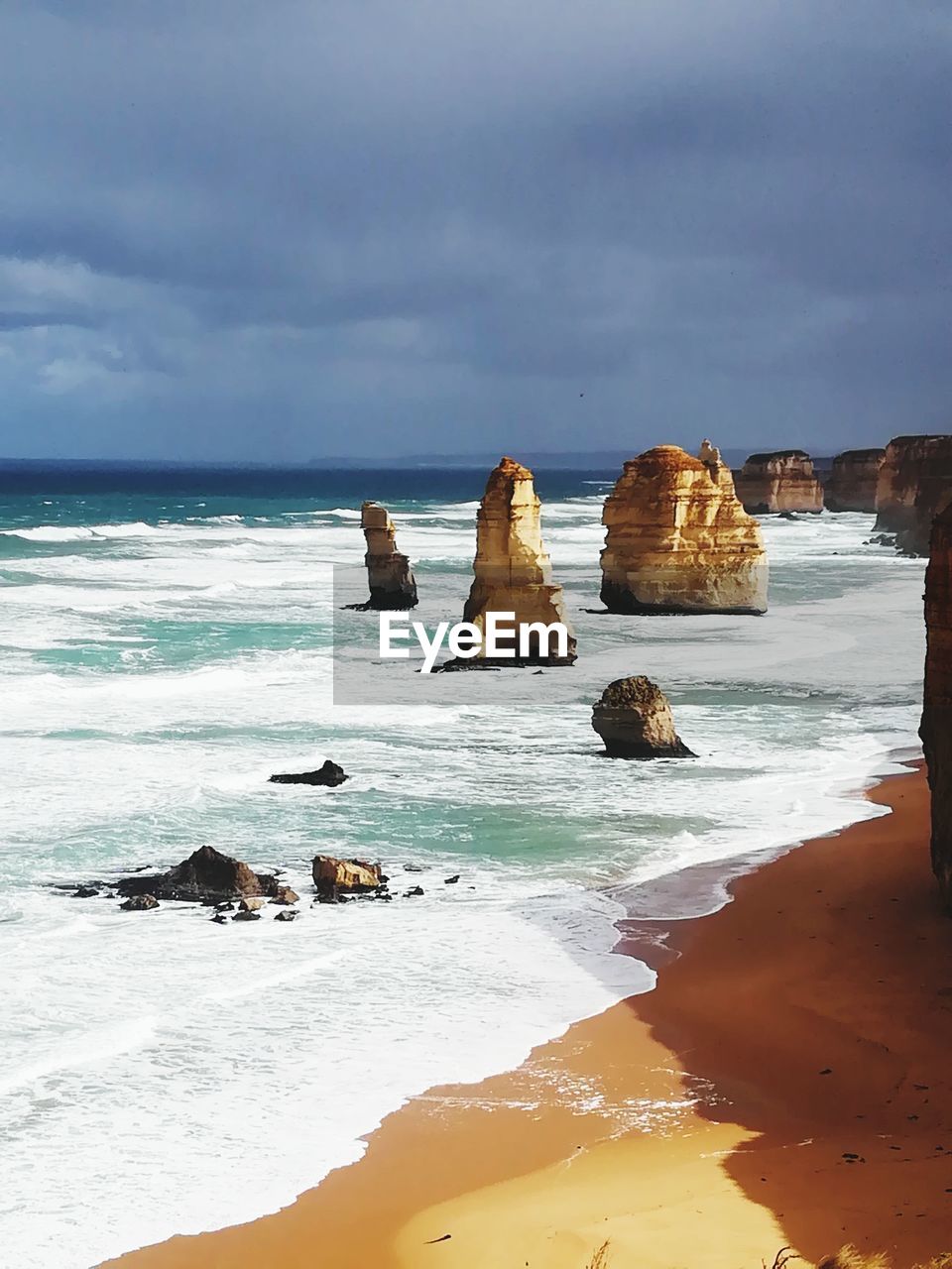 ROCKS ON SHORE AGAINST SKY