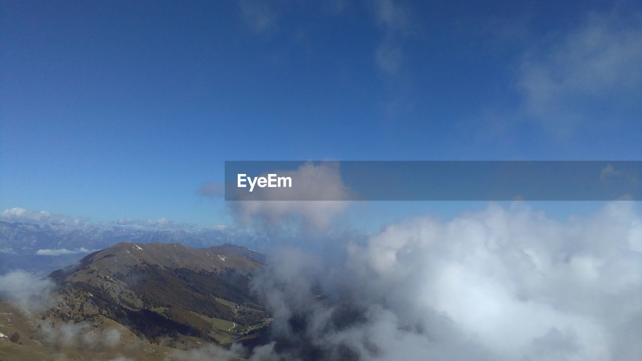 SCENIC VIEW OF CLOUDS OVER MOUNTAIN