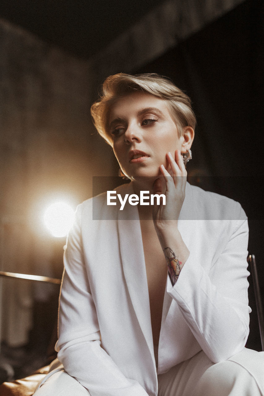 Young stylish woman businesswoman in white suit