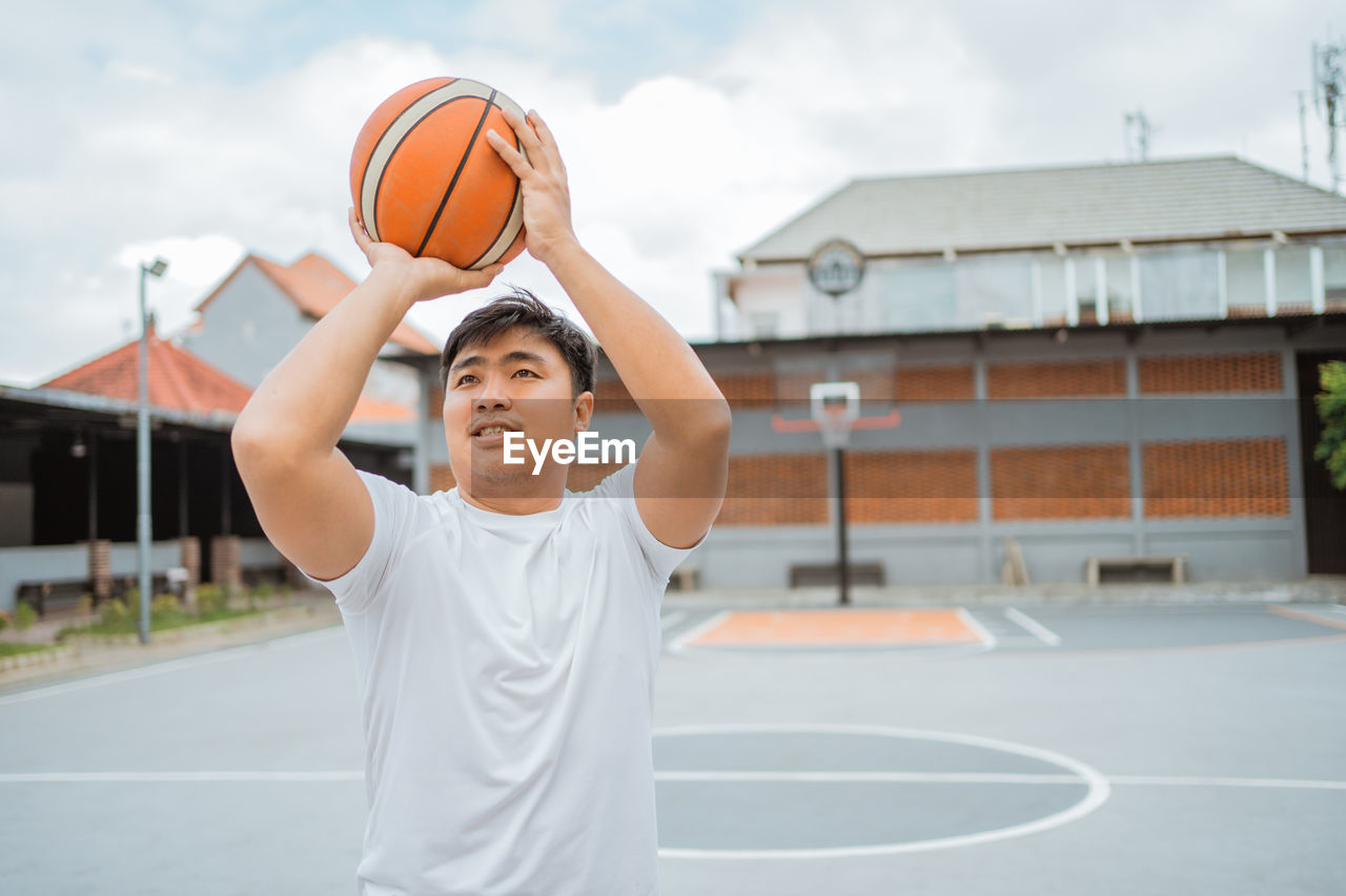 Man playing with ball on basketball court