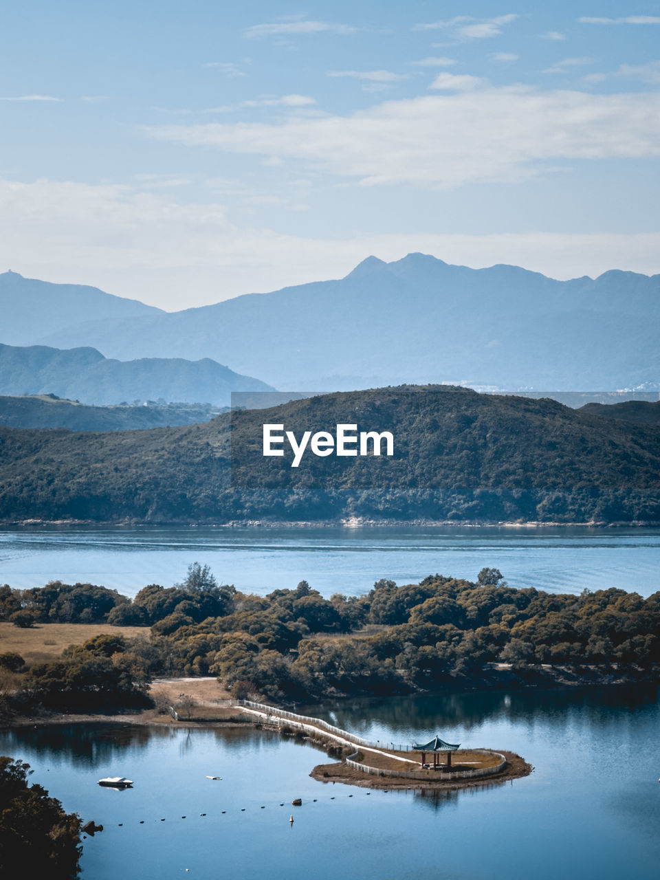 Scenic view of lake and mountains against sky