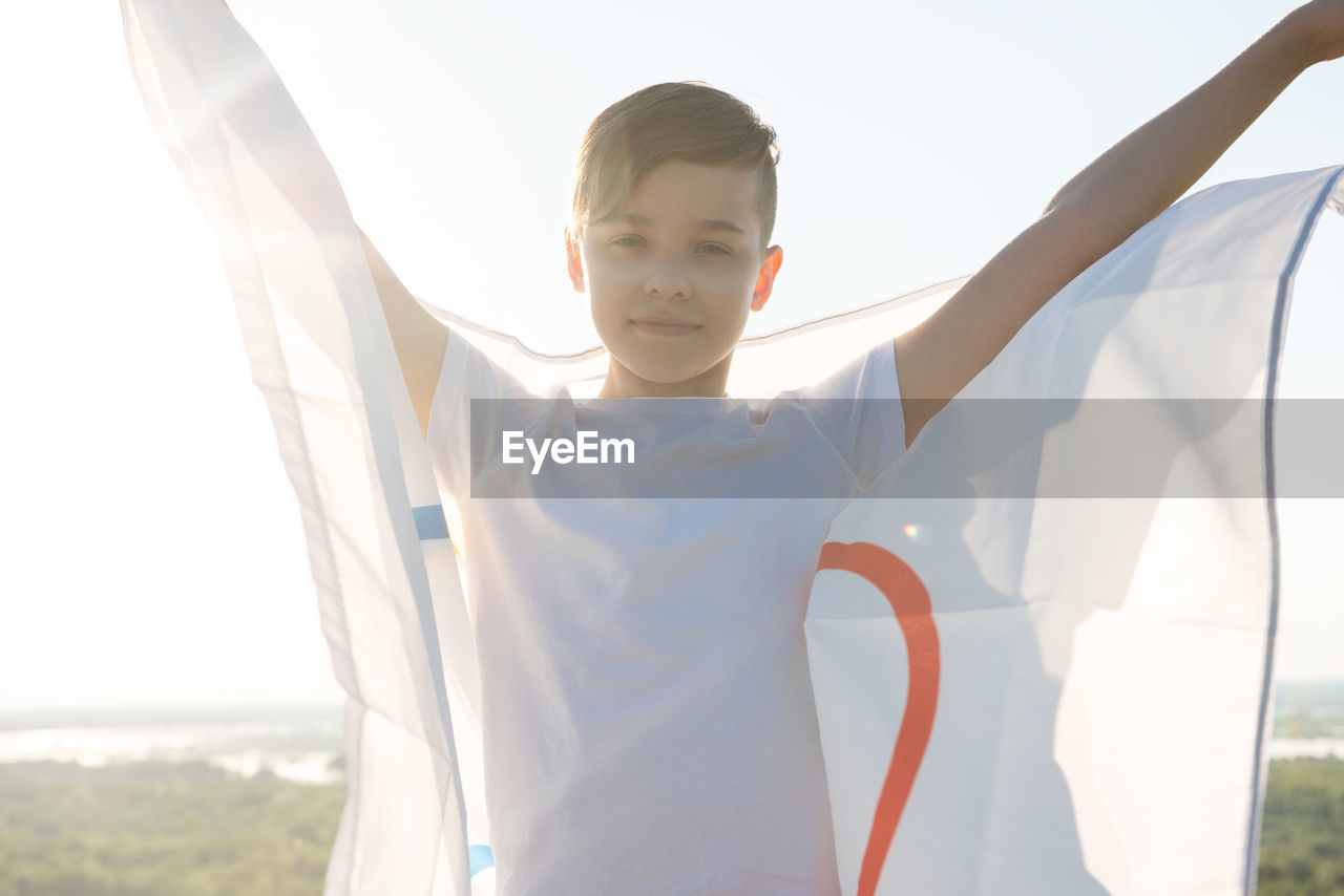 Portrait of boy holding flag