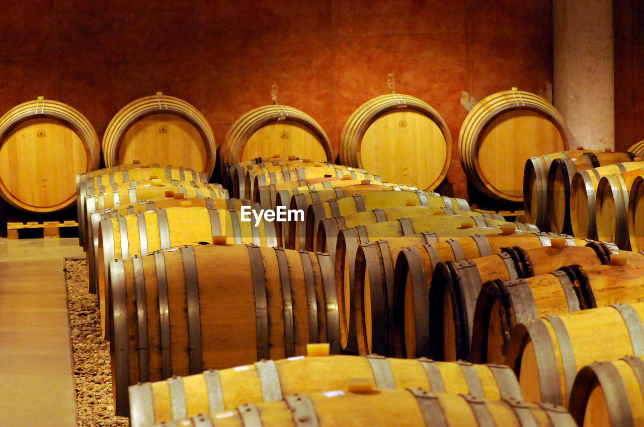 Many wooden barrels in a wine cellar, storage of wine