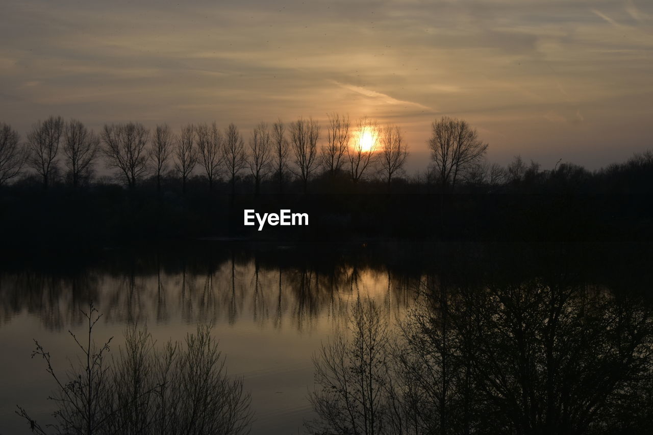 Scenic view of lake against sky during sunset