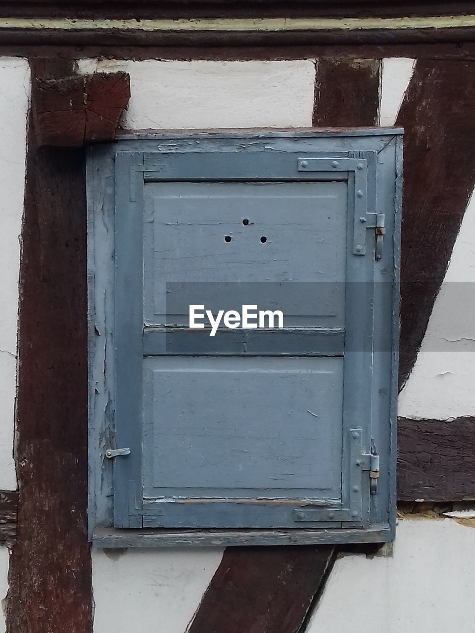 CLOSED BLUE DOOR OF OLD BUILDING