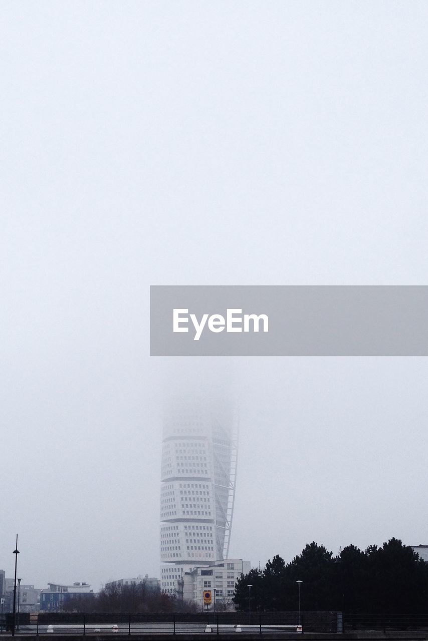 Skyscraper among fog