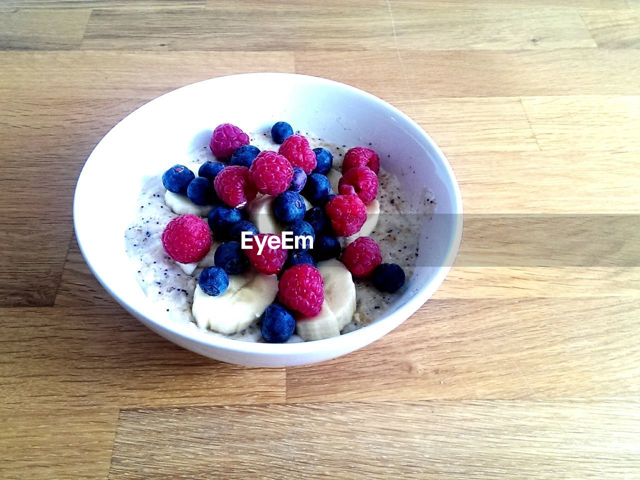 Healthy breakfast with muesli and fruits on table