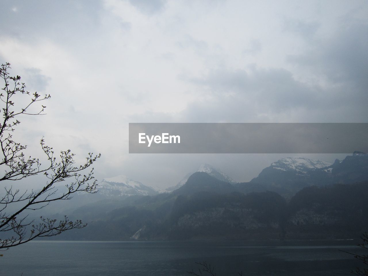 SCENIC VIEW OF MOUNTAINS AGAINST CLOUDY SKY