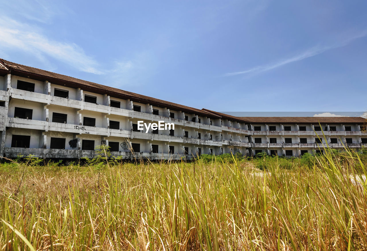 Built structure on field against sky