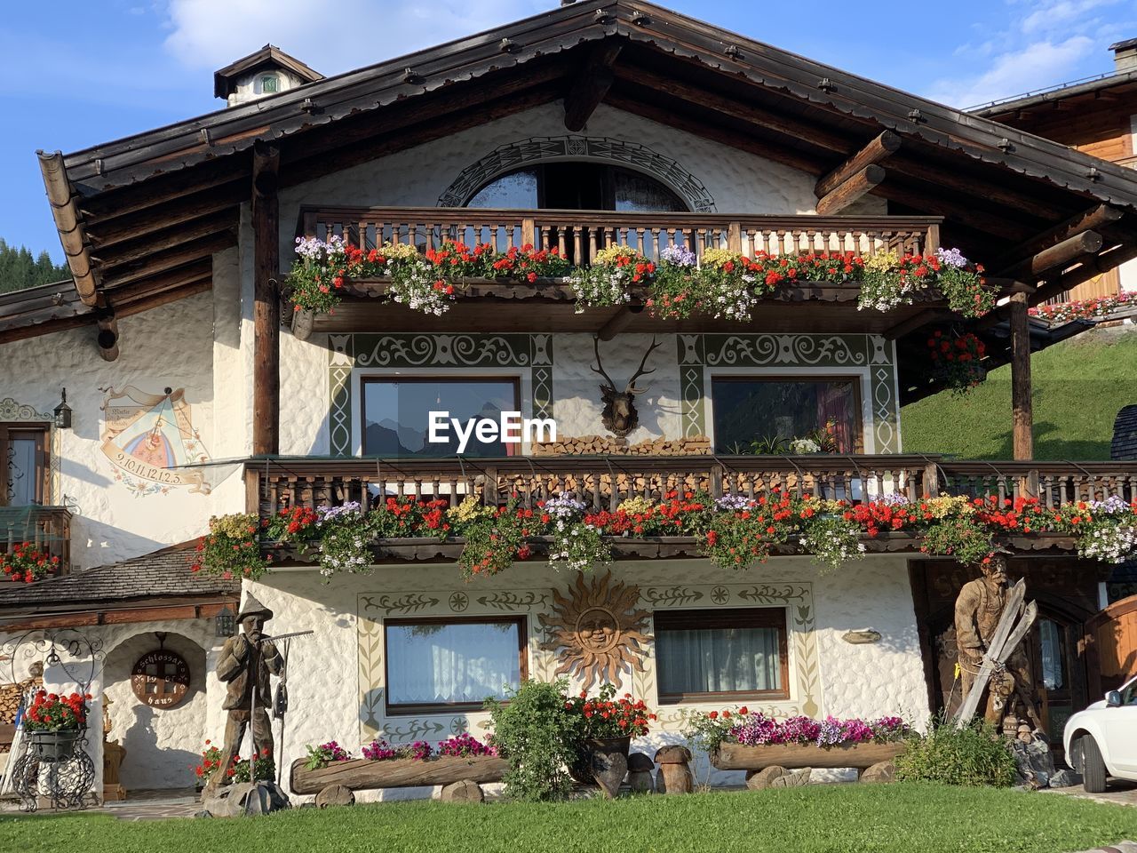 LOW ANGLE VIEW OF POTTED PLANTS ON BUILDING AGAINST SKY