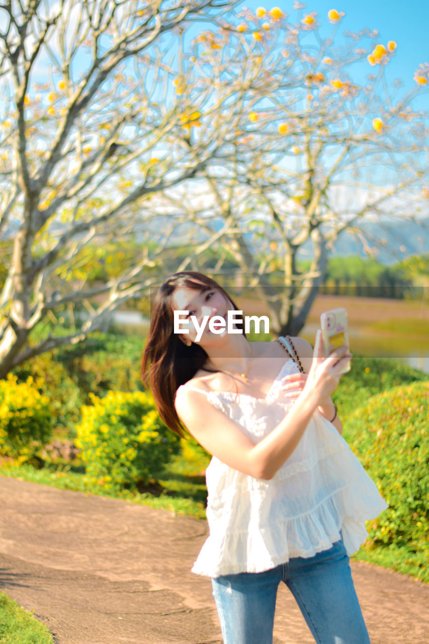 Young woman holding flower