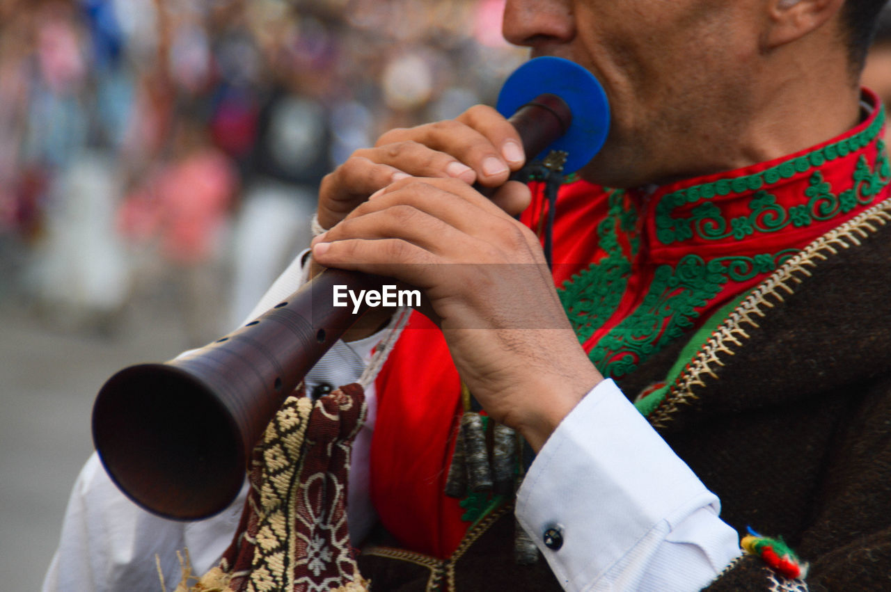 Midsection of man playing the trumpet