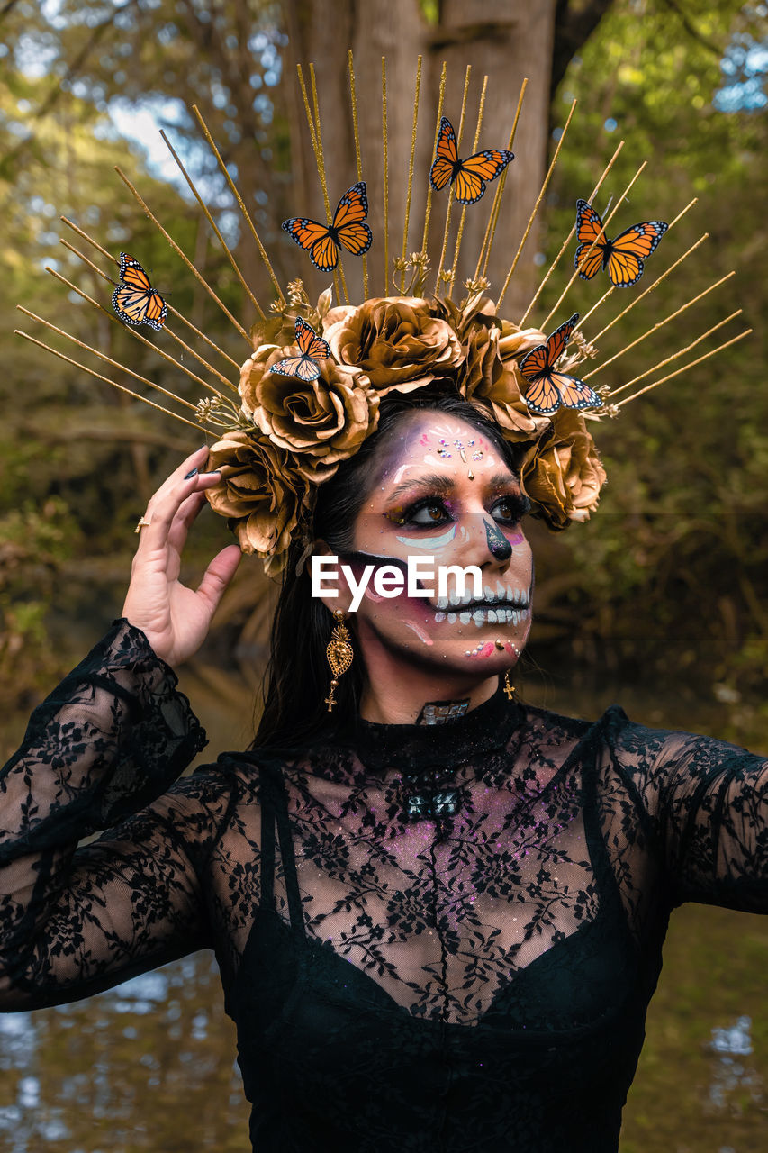 Portrait of young woman wearing day of the deas makeup in mexico