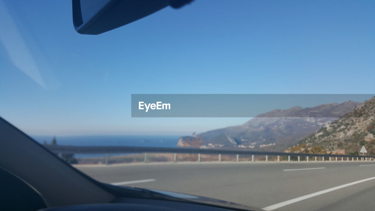 CROPPED IMAGE OF AIRPLANE WING OVER LANDSCAPE