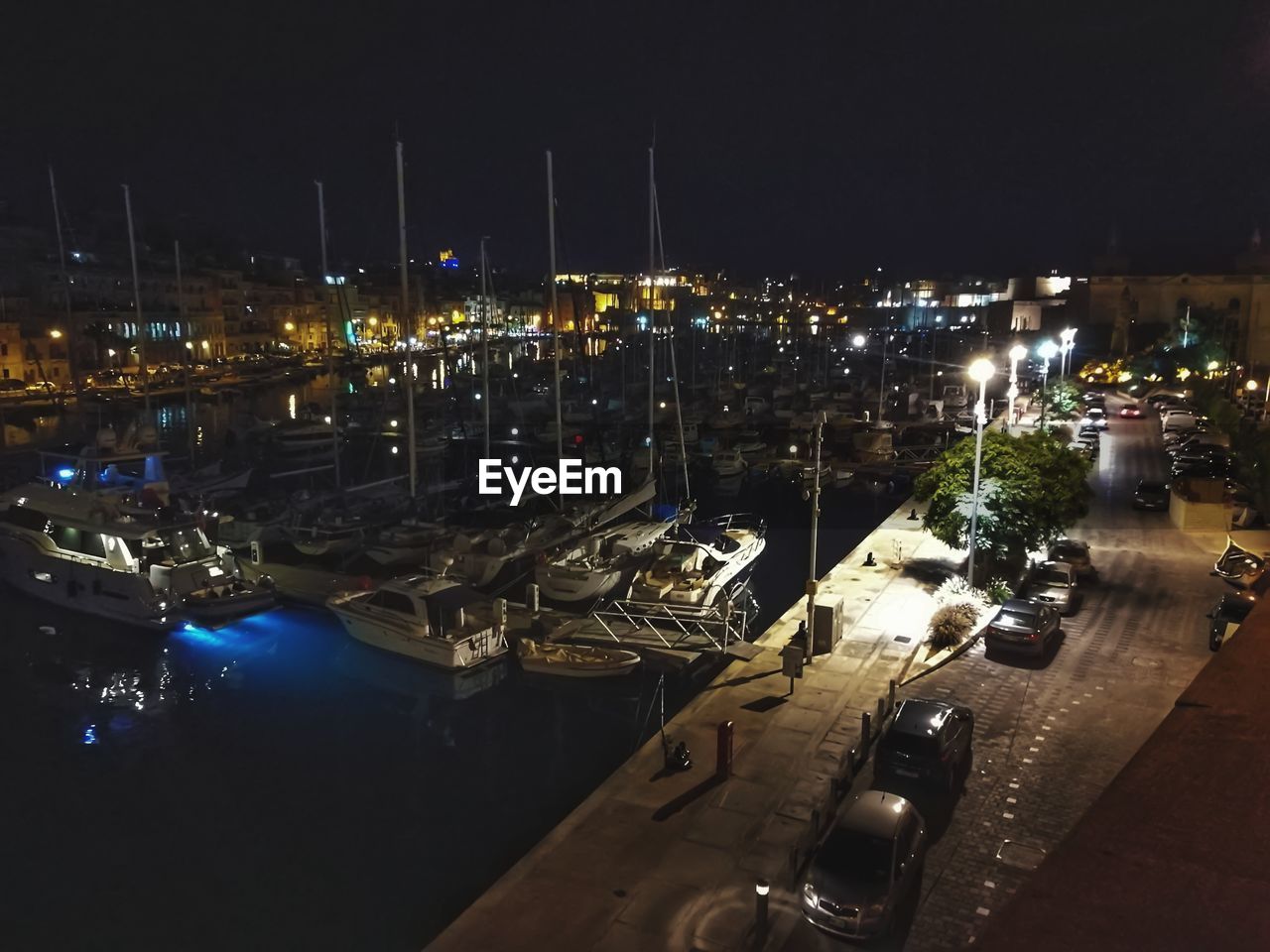 HIGH ANGLE VIEW OF ILLUMINATED CITY AT NIGHT