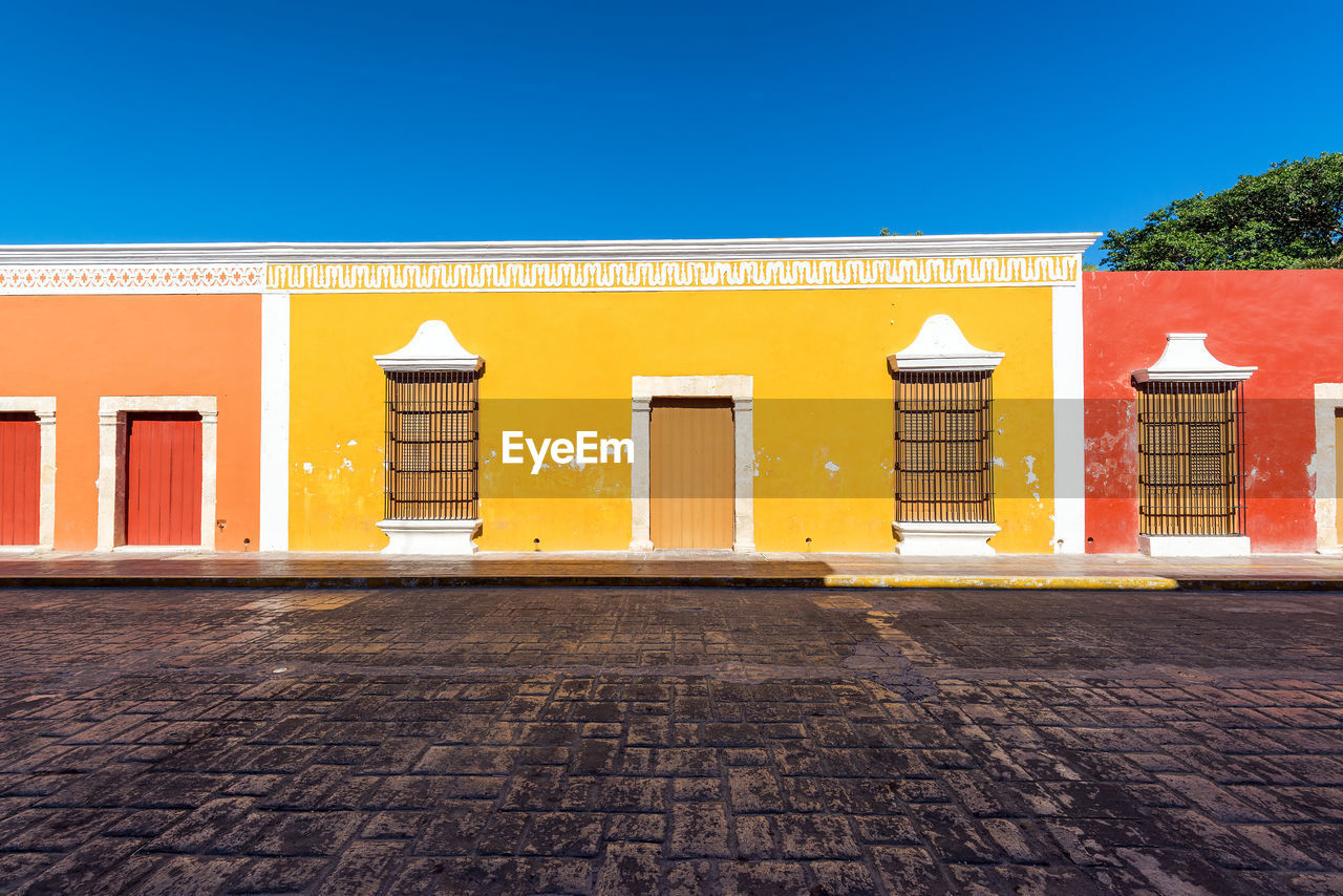 Yellow building against clear sky