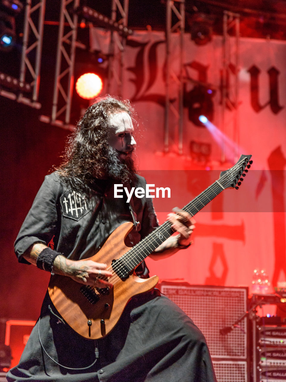 MAN PLAYING GUITAR ON STAGE