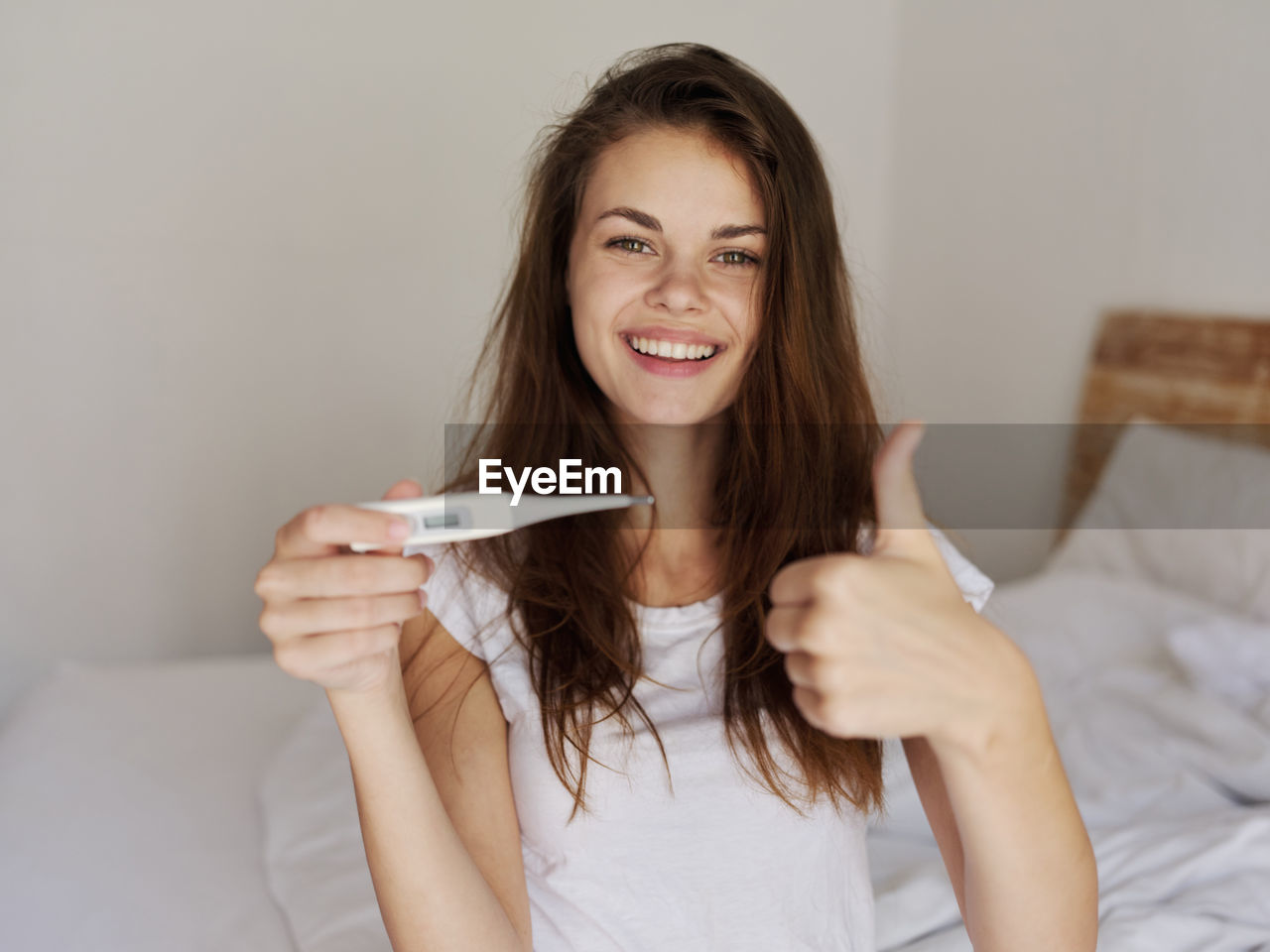 Portrait of beautiful woman smiling in bed