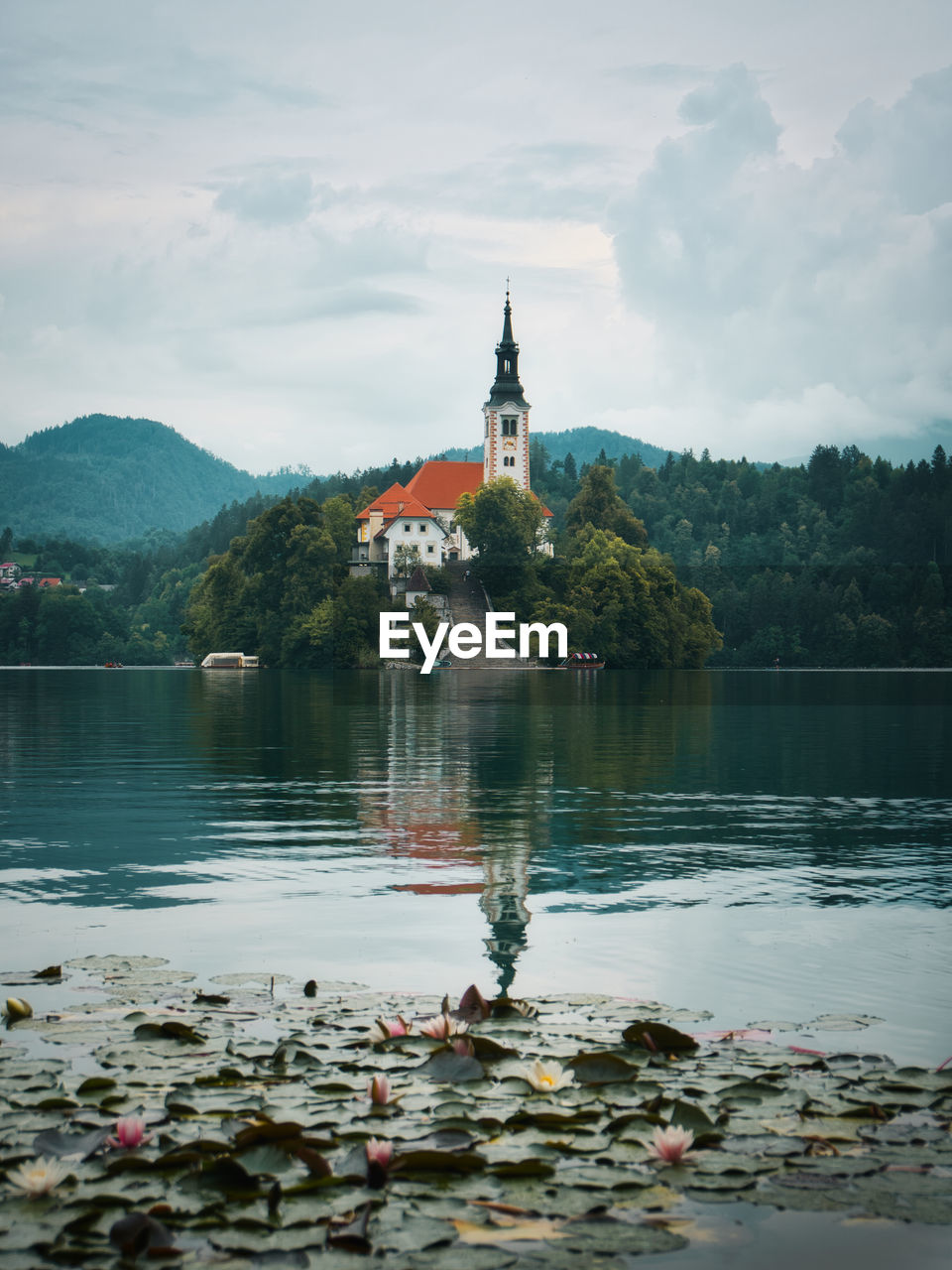 Scenic view of lake and buildings against sky, church on island at lake bled, slovenia