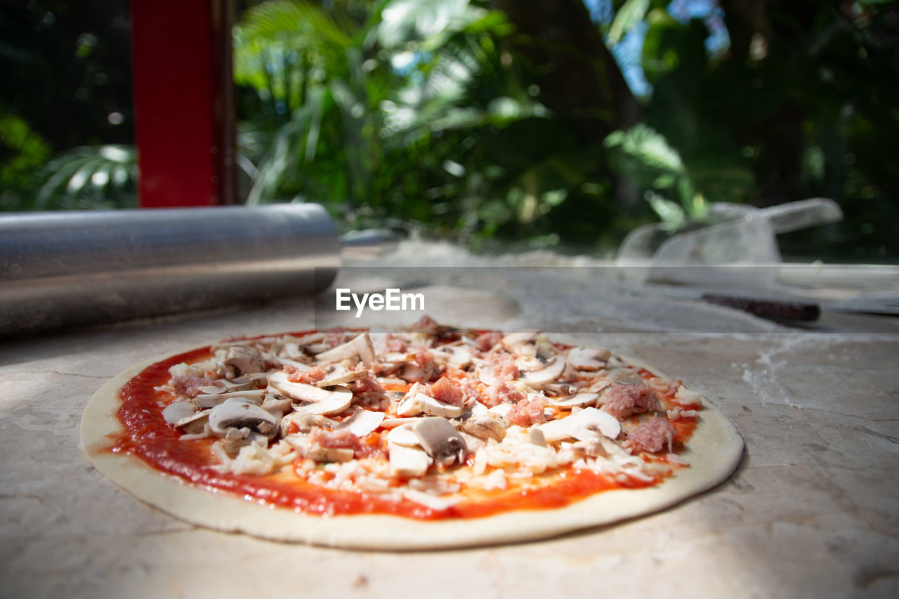 food and drink, food, pizza, dish, fast food, cuisine, italian food, freshness, no people, vegetable, day, cheese, meal, table, dairy, outdoors, focus on foreground, plant, pepperoni, fruit