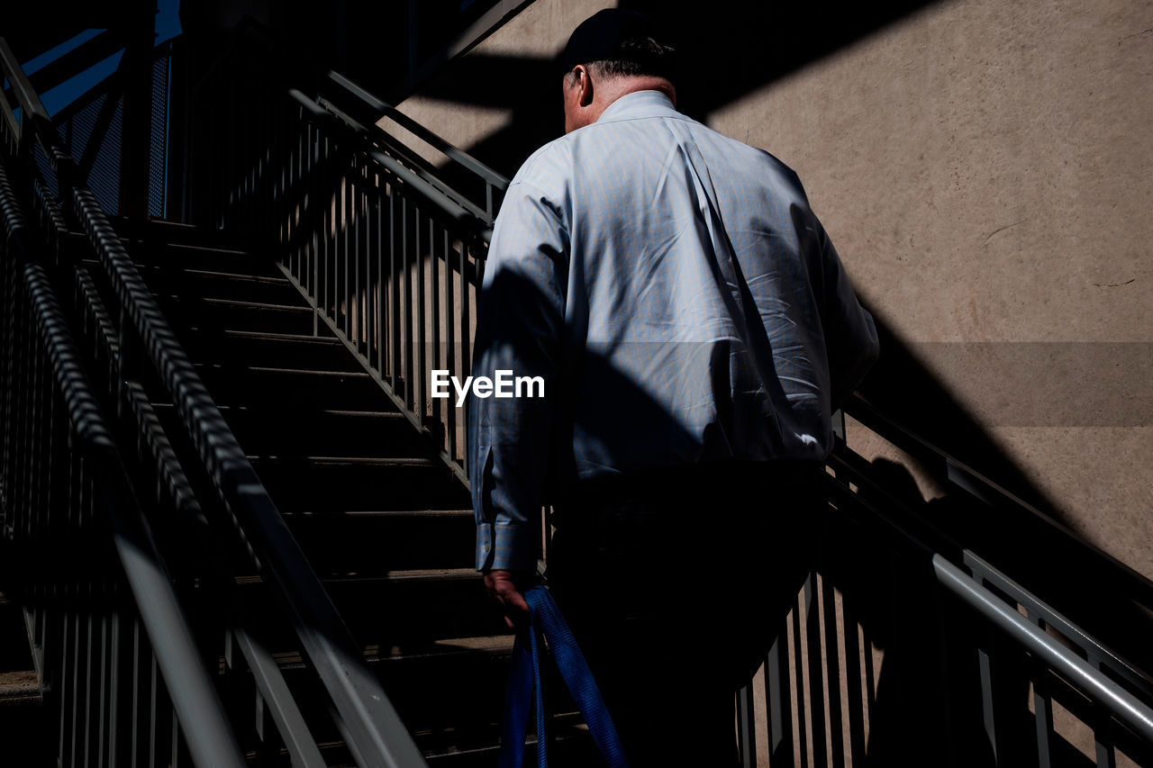 Rear view of man on staircase