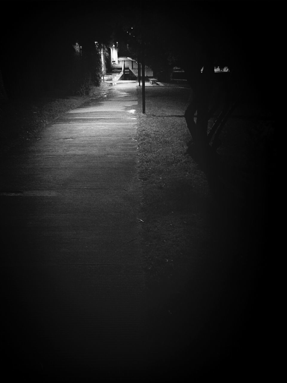 ILLUMINATED EMPTY ROAD AT NIGHT