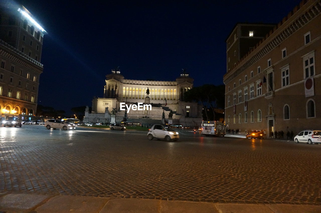 VIEW OF CITY STREET AT NIGHT