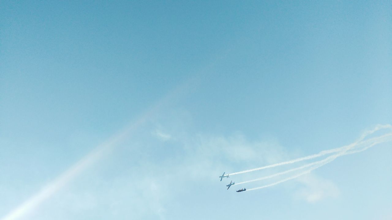 Low angle view of airshow in sky