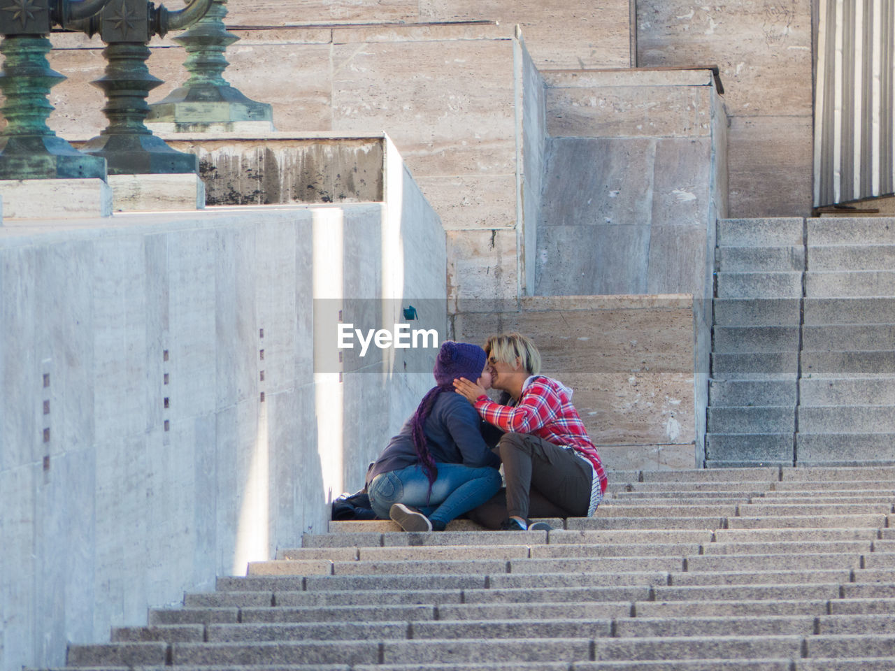 Teenager couple kissing on staircase