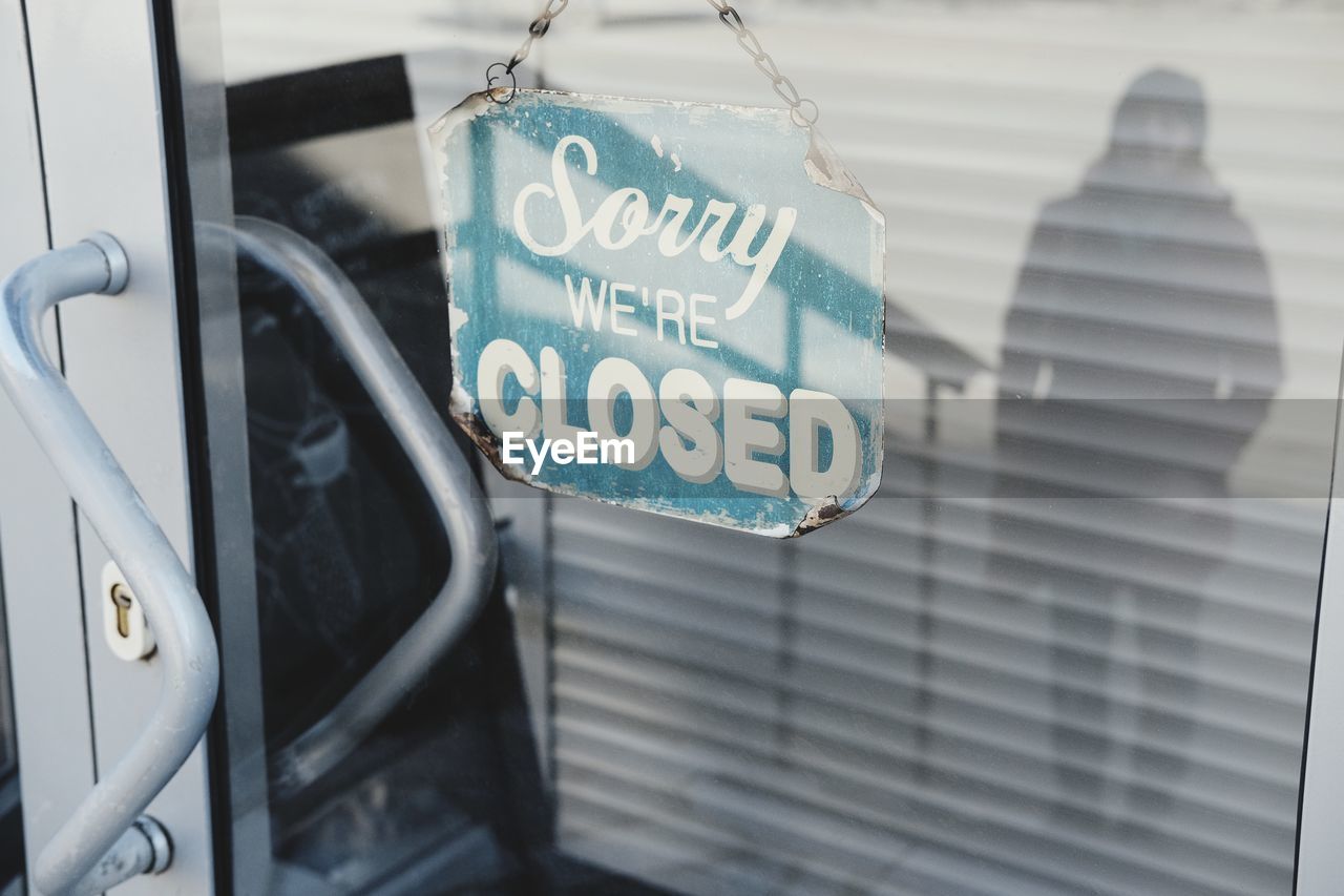 CLOSE-UP OF INFORMATION SIGN ON WINDOW