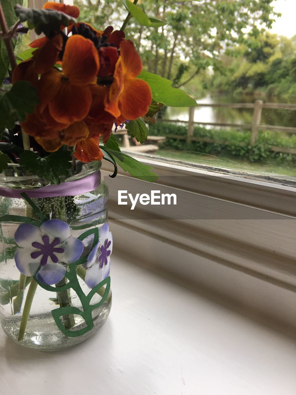 CLOSE-UP OF VASE IN JAR ON TABLE