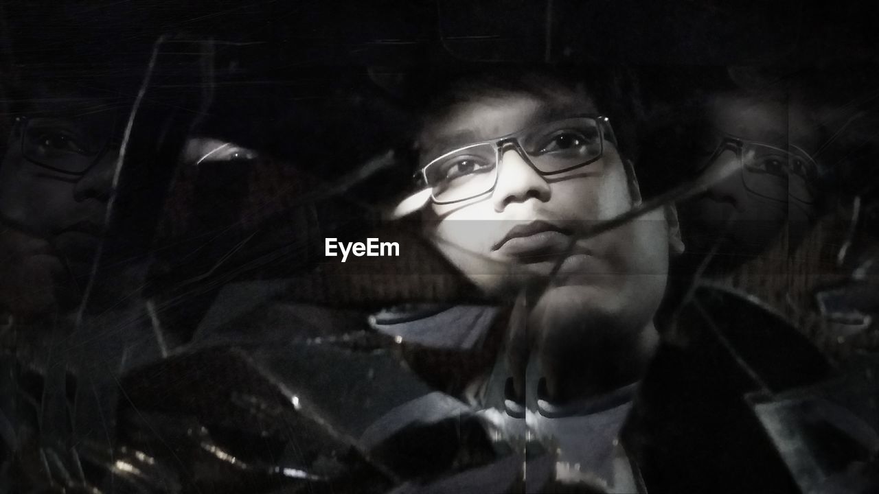Reflection of man on broken mirror