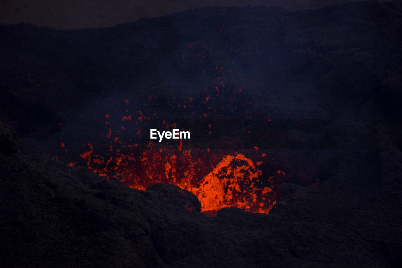 volcano, lava, geology, mountain, erupting, power in nature, heat, land, smoke, nature, no people, landscape, environment, active volcano, beauty in nature, sign, volcanic landscape, molten, physical geography, island, night, non-urban scene, warning sign, communication, volcanic activity, outdoors, burning, volcanic crater, volcanic rock, glowing, exploding