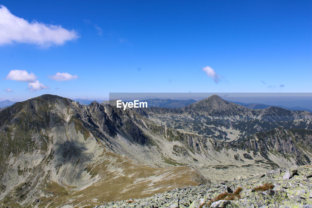 SCENIC VIEW OF MOUNTAIN AGAINST BLUE SKY