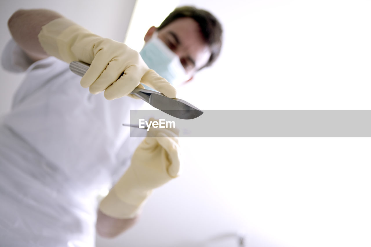 CLOSE-UP OF MAN WORKING WITH ARMS