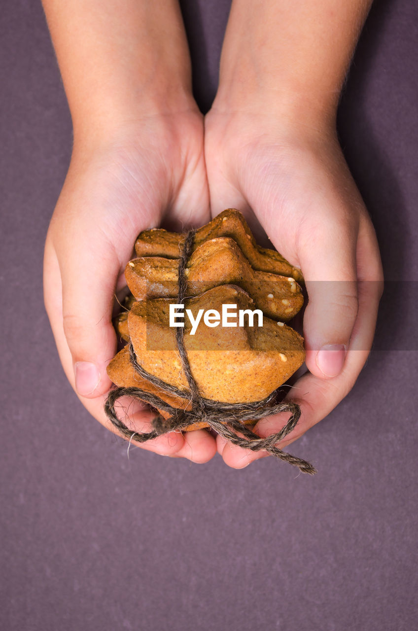 High angle view of human hand holding cookies
