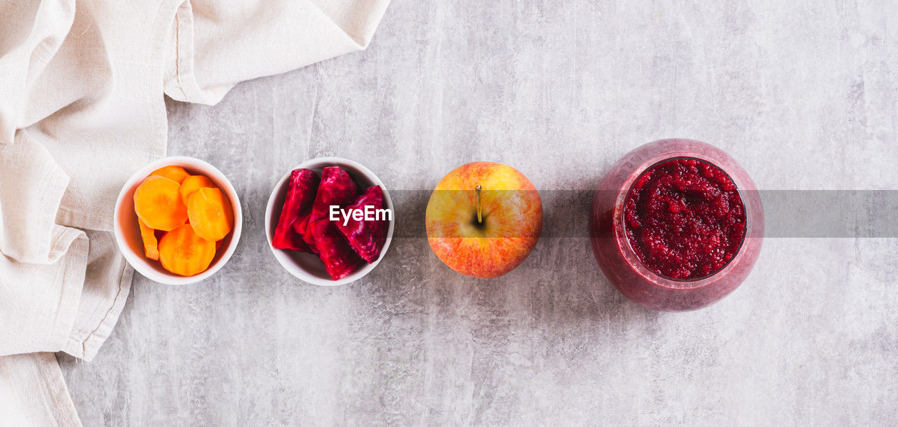 food and drink, food, healthy eating, red, freshness, fruit, wellbeing, studio shot, high angle view, indoors, directly above, wood, no people, plant, textile, petal, still life, produce, pink, berry, orange color, bowl