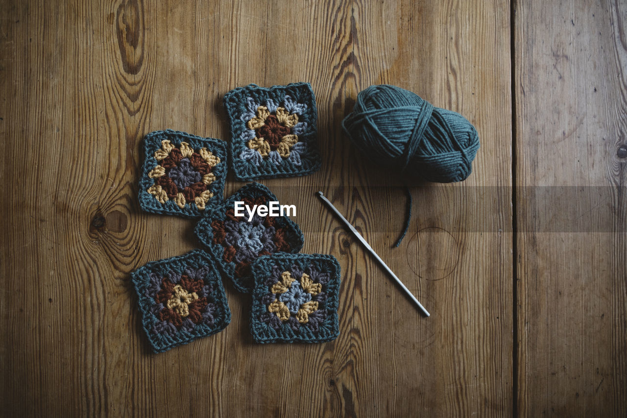 Crochet squares on wooden background