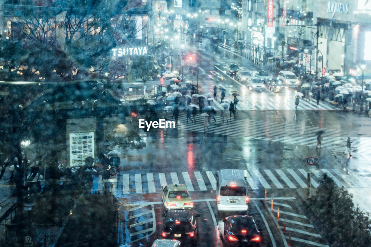 HIGH ANGLE VIEW OF ILLUMINATED CITY STREET