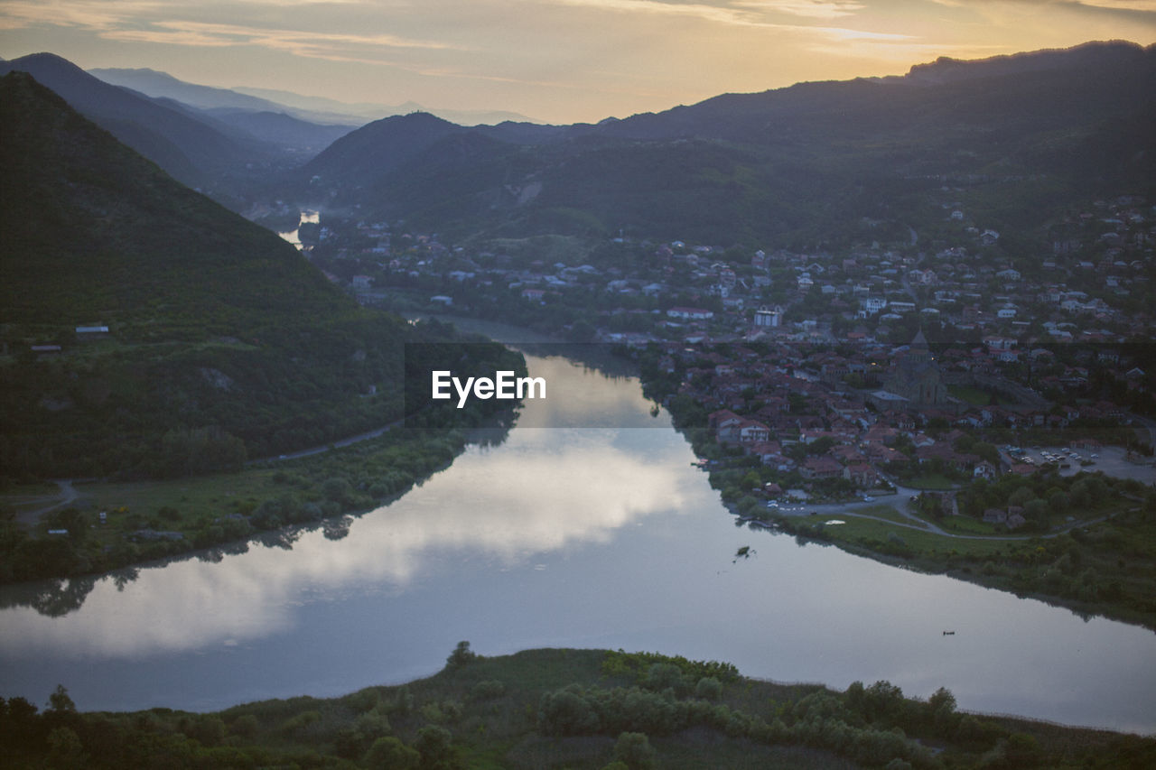 Scenic view of lake and mountains against sky